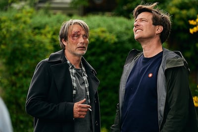 This image released by Samuel Goldwyn Films shows Mads Mikkelsen, left, with director Thomas Vinterberg on the set of "Another Round."  (Samuel Goldwyn Films via AP)