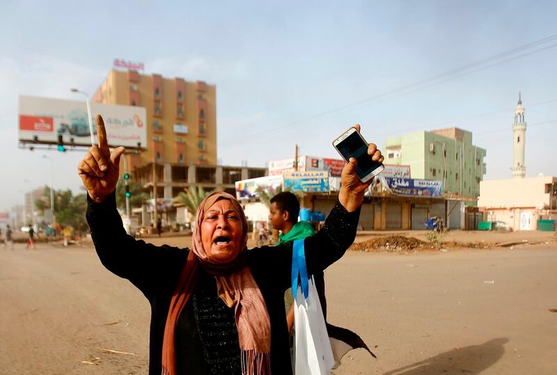 A Sudanese protester reacts as the military forces tried to disperse the sit-in outside Khartoum's army headquarters. AFP