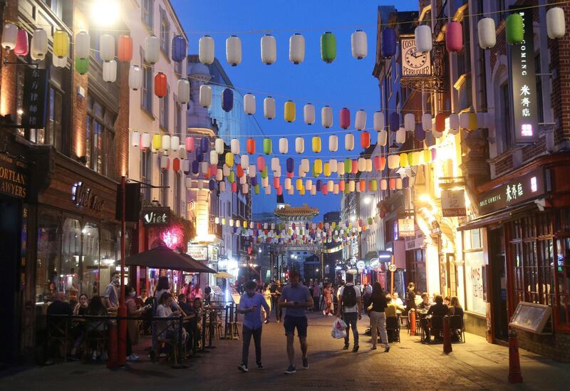 People dine out in Chinatown, London. PA via AP