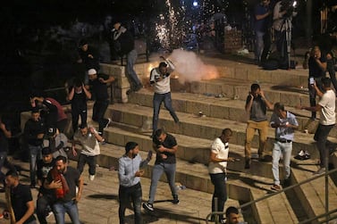 Palestinian protesters run from stun grenades fired by Israeli security forces outside the Damascus Gate in Jerusalem's Old City on May 8, 2021. AFP 