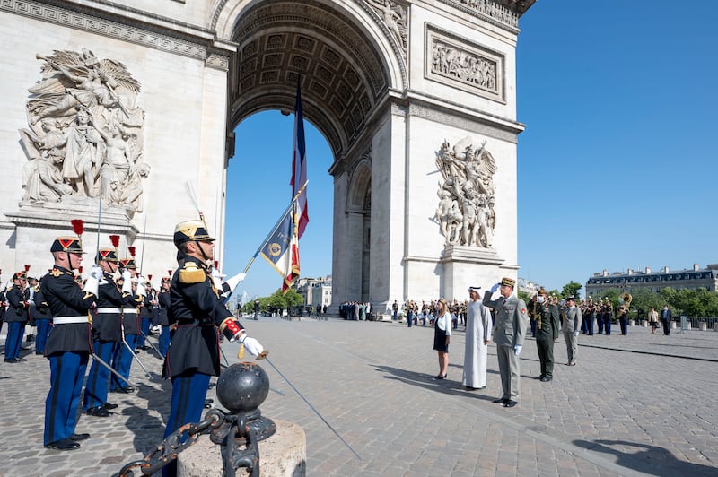 Sheikh Mohamed stands at attention as the national anthems of the UAE and France are played at the Arc de Triomphe. Photo: Presidential Court