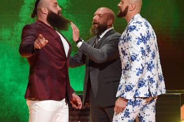 Braun Strowman, left, and Tyson Fury, right, is separated by Triple H at a press conference to announce their WWE fight in Saudi Arabia. AFP