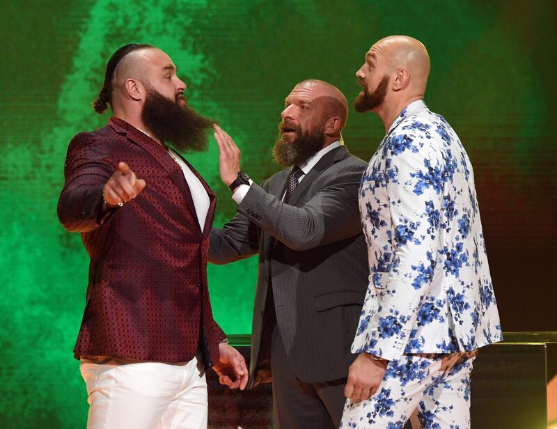 LAS VEGAS, NEVADA - OCTOBER 11: WWE Executive Vice President of Talent, Live Events and Creative Paul "Triple H" Levesque (C) gets between WWE wrestler Braun Strowman (L) and heavyweight boxer Tyson Fury (R) as they face off during the announcement of their match at a WWE news conference at T-Mobile Arena on October 11, 2019 in Las Vegas, Nevada. Strowman will face Fury and WWE champion Brock Lesnar will take on former UFC heavyweight champion Cain Velasquez at the WWE's Crown Jewel event at Fahd International Stadium in Riyadh, Saudi Arabia on October 31.   Ethan Miller/Getty Images/AFP
== FOR NEWSPAPERS, INTERNET, TELCOS & TELEVISION USE ONLY ==
