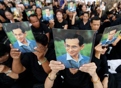 epa06285502 Thai mourners hold the portrait of the late Thai King Bhumibol Adulyadej as they line up to wait to take part in the Royal Cremation ceremony of late King Bhumibol Adulyadej, near of Sanam Luang in Bangkok, Thailand, 24 October 2017. The Royal Cremation ceremony of late King Bhumibol Adulyadej is scheduled on 26 October 2017, and the funeral will consist of five days of rites. King Bhumibol died at the age of 88 in Siriraj hospital on 13 October 2016 after 70 years on the throne.  EPA/NARONG SANGNAK