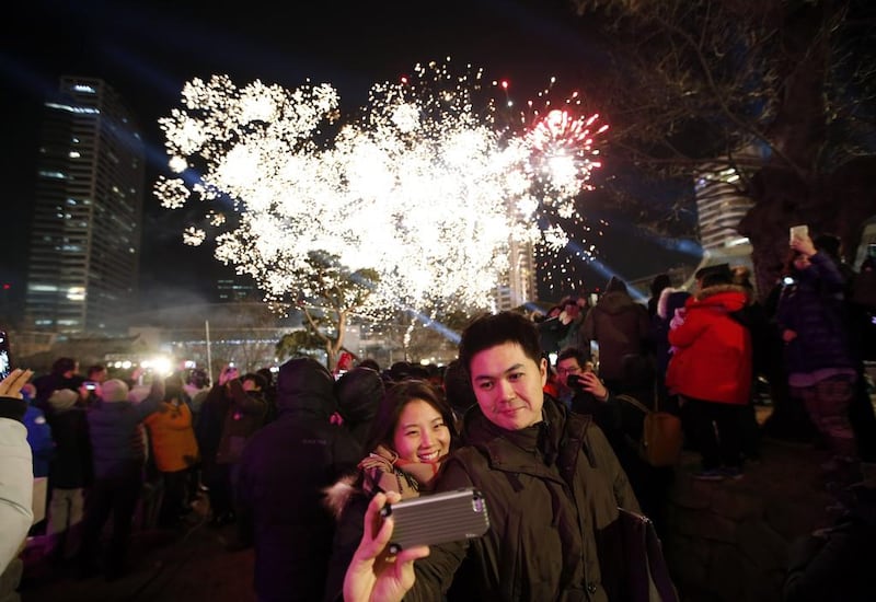 A couple takes a "selfie" as fireworks go off during a ceremony to celebrate the new year at Bongeun Buddhist temple in Seoul on January 1, 2015.  Kim Hong-Ji/Reuters
