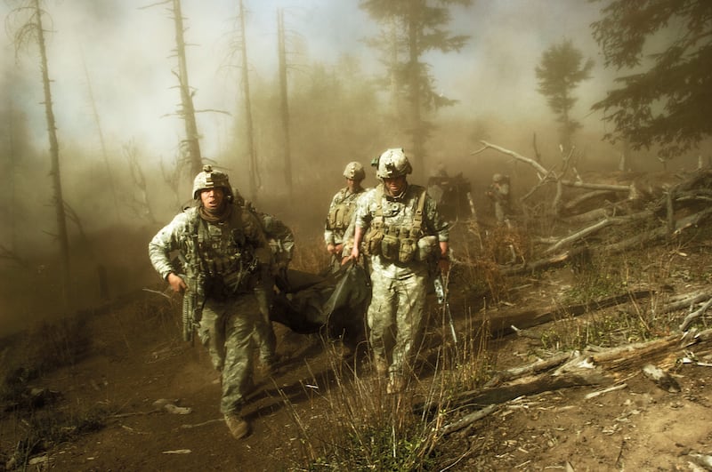 US troops carry the body of Staff Sergeant Larry Rougle, who was killed when Taliban insurgents ambushed their squad in the Korengal Valley, Afghanistan, in October 2007. 