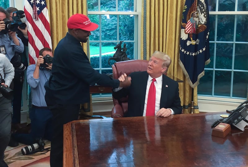 (Files) in this file photo US President Donald Trump meets with rapper Kanye West in the Oval Office of the White House in Washington, DC, October 11, 2018. Rapper Kanye West, who has been outspoken in his support for President Donald Trump, now says he's going to focus on his music and fashion after being "used" in the world of politics, October 30, 2018. / AFP / SEBASTIAN SMITH
