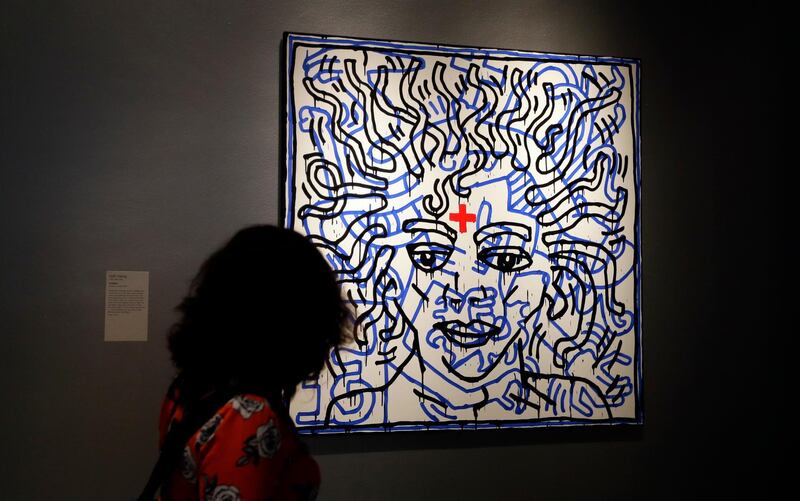 A woman looks at an artwork by Keith Haring called "Untitled" on display at "Michael Jackson: On the Wall" at the National Portrait Gallery in London, Britain, on June 27, 2018. Kirsty Wigglesworth / AP Photo