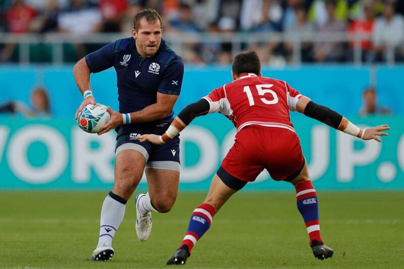 Scotland's flanker Fraser Brown (L) looks to pass past Russia's full back Vasily Artemyev during the Japan 2019 Rugby World Cup Pool A match between Scotland and Russia at the Shizuoka Stadium Ecopa in Shizuoka. AFP