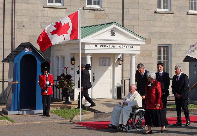 Pope Francis walks with Ms Simon and Mr Trudeau. Reuters