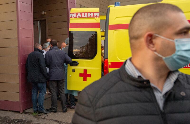 Russian medics put opposition politician Alexei Navalny into an ambulance to transport him from an emergency care hospital to an airport. EPA