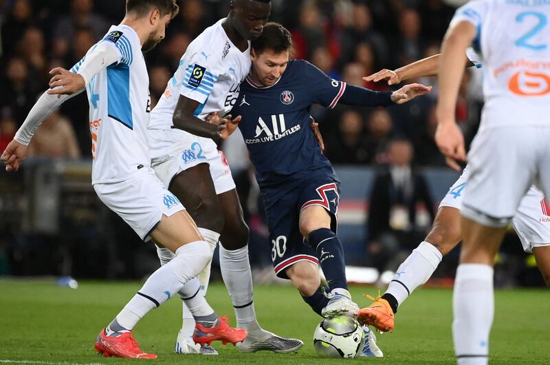 Paris Saint-Germain's Lionel Messi fights for the ball with Marseille's French midfielder Pape Gueye. AFP