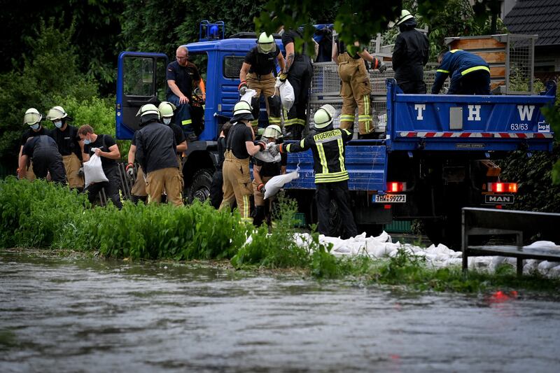 Firefighters and rescue crews place sandbags along the banks of the Duessel river, Germany. EPA