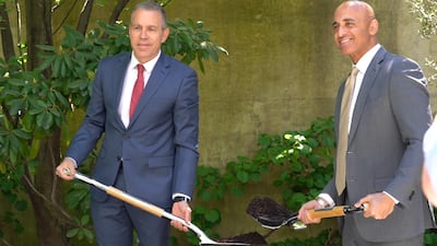The UAE’s ambassador and Minister of State Yousef Al Otaiba, right, and Israel’s ambassador to the US and the UN, Gilad Erdan, plant an olive tree. Katarina Holtzapple / The National