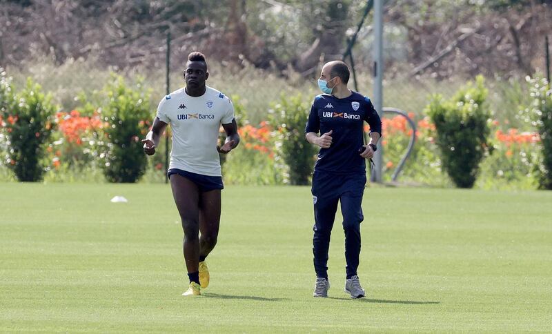 Mario Balotelli and a fitness coach Stefano Cellio during a training session. EPA