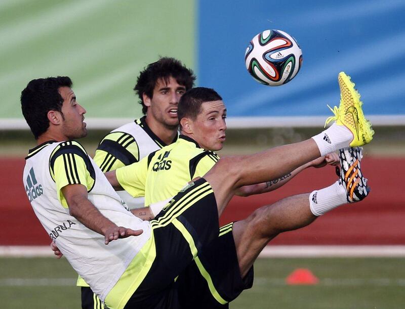 Spain players Sergio Busquets, front, Fernando Torres, centre, and Javi Martinez, back, take part in Monday's training session for the World Cup. Sergio Perez / Reuters / May 26, 2014