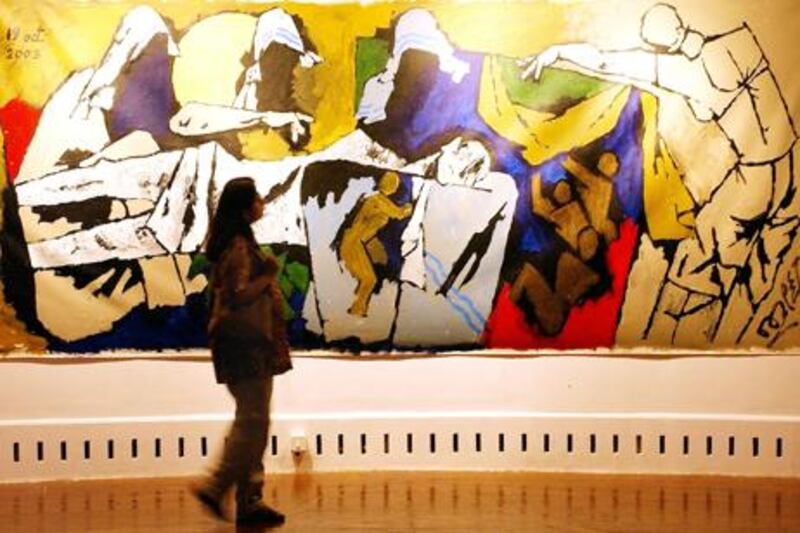 (FILES) In this photograph taken on January 14, 2004, a visitor looks at a huge painting called "Pieta" by Indian artist Maqbool Fida (MF) Hussain at the inauguration of the exhibition '...and not only 88 of Hussain' at the National Art Gallery in Bombay.   India's most famous modern artist M.F. Husain, who left the country in 2006 due to threats from Hindu extremists, died early June 9, 2011, in London, media reports in New Delhi said citing his family. Husain, who was aged 95 and known as the "Picasso of India", died at the Royal Brompton hospital in London, the Press Trust of India news agency said. Indian television news channels reported he had suffered a heart attack and lung failure. AFP PHOTO/Sebastian D'SOUZA/FILES

