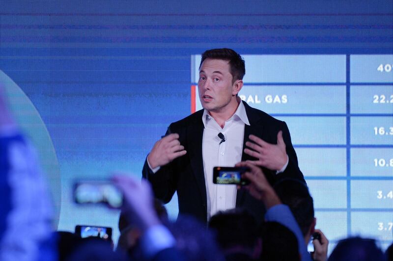 Elon Musk, co-founder and chief executive officer of Tesla Inc., speaks during an event at the Hornsdale wind farm, operated by Neoen SAS, near Jamestown, South Australia, on Friday, Sept. 29, 2017. Against a backdrop of wind turbines 150 miles (241 kilometers) north of Adelaide, Musk announced a contract to build the world's largest lithium-ion battery system had been signed with South Australia's power distributor, triggering a 100-day self-imposed deadline to install the electricity storage system. Photographer: Carla Gottgens/Bloomberg