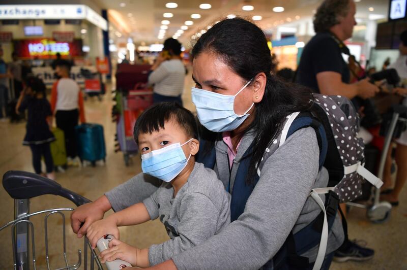Passengers wear protective masks on arrival at Sydney International Airport in Sydney, Australia. EPA