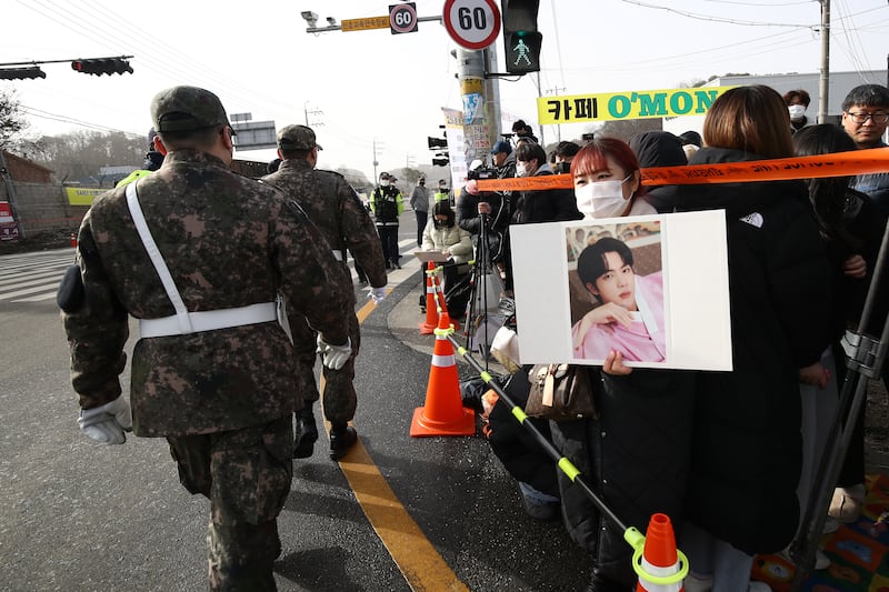Fans wait in front of the boot camp as they hope to catch a glimpse of Jin. Getty