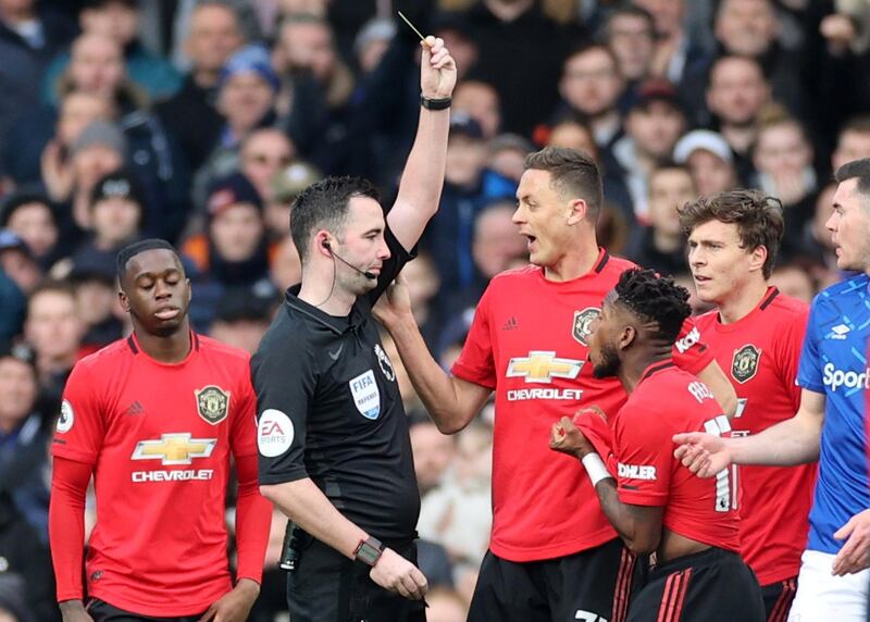 Manchester United's Fred is shown a yellow card by referee Chris Kavanagh. Reuters
