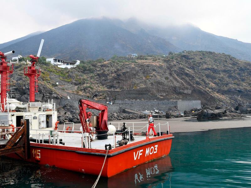 A firefighters' boat docks at the village of Ginostra, on the small Sicilian island of Stromboli, southern Italy, a day after the Stromboli volcano, seen in the background, erupted. Civil protection authorities said a hiker was killed during the eruptions on Wednesday which sent about 30 tourists jumping into the sea for safety. AP