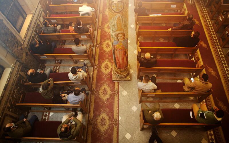Worshippers attend Midnight Mass at the Church of St George in Cairo. Capacity at churches has been reduced due to the pandemic. AP Photo