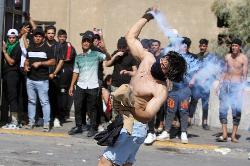 A protester hurls a tear gas canister. Reuters