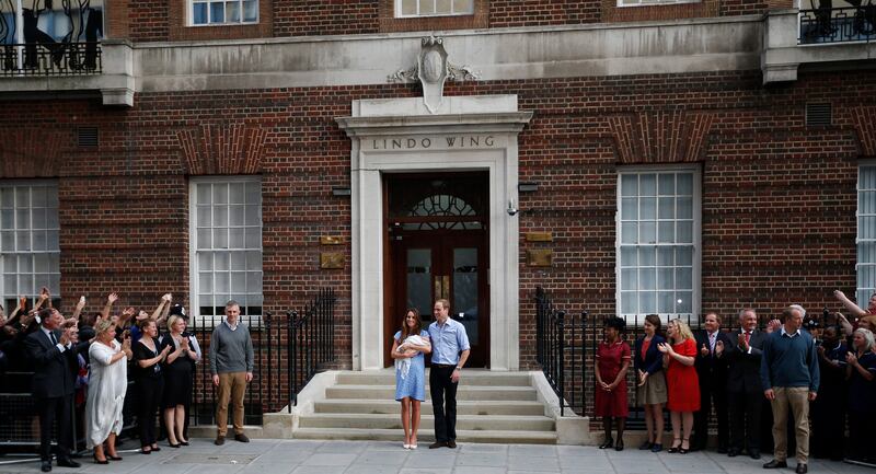 Britain's Prince William, centre right, and Kate, Duchess of Cambridge hold the Prince of Cambridge, Tuesday July 23, 2013, as they pose for photographers outside St. Mary's Hospital exclusive Lindo Wing in London where the Duchess gave birth on Monday July 22. The Royal couple are expected to head to London’s Kensington Palace from the hospital with their newly born son, the third in line to the British throne. (AP Photo/Lefteris Pitarakis) *** Local Caption ***  Britain Royal Baby.JPEG-0c44c.jpg