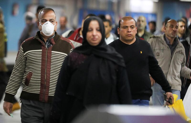 A man wearing a protective face mask walks at the underground Al Shohadaa "Martyrs" metro station while Egypt ramps up its efforts to slow down the spread of the coronavirus disease (COVID-19) in Cairo, Egypt March 22, 2020. REUTERS/Mohamed Abd El Ghany