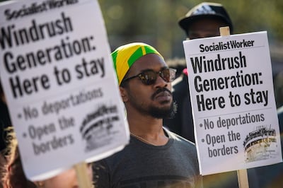 LONDON, ENGLAND - APRIL 20:  Demonstrators hold placards during a protest in support of the Windrush generation in Windrush Square, Brixton on April 20, 2018 in London, England. The Windrush generation are people who arrived in the UK after the second world war from Caribbean countries at the invitation of the British government. It is now thought that an estimated 50,000 people of the Windrush generation face the risk of deportation if they never formalised their residency status and do not have the required documentation to prove it.  (Photo by Chris J Ratcliffe/Getty Images)