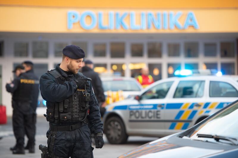 epa08058946 Police officers stand guard at the crime scene in front of a hospital in Ostrava, Czech Republic, 10 December 2019. According to police, four people have been killed in a shooting at a hospital in Ostrava. Two others suffered severe injuries in the incident. The police is looking for a suspected gunman who is at large, media reported.  EPA/LUKAS KABON