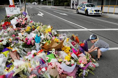 A boy places flowers at a memorial as a tribute to victims of the mosque attacks, near a police line outside Masjid Al Noor in Christchurch, New Zealand, March 16, 2019. REUTERS/Jorge Silva     TPX IMAGES OF THE DAY