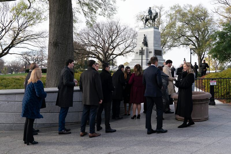 Some guests were given hand warmers as they waited in line for the ceremony. AP