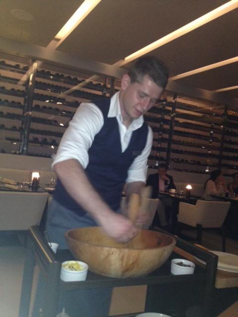 A waiter whipping up a Caesar salad. Photo by Ann Marie McQueen