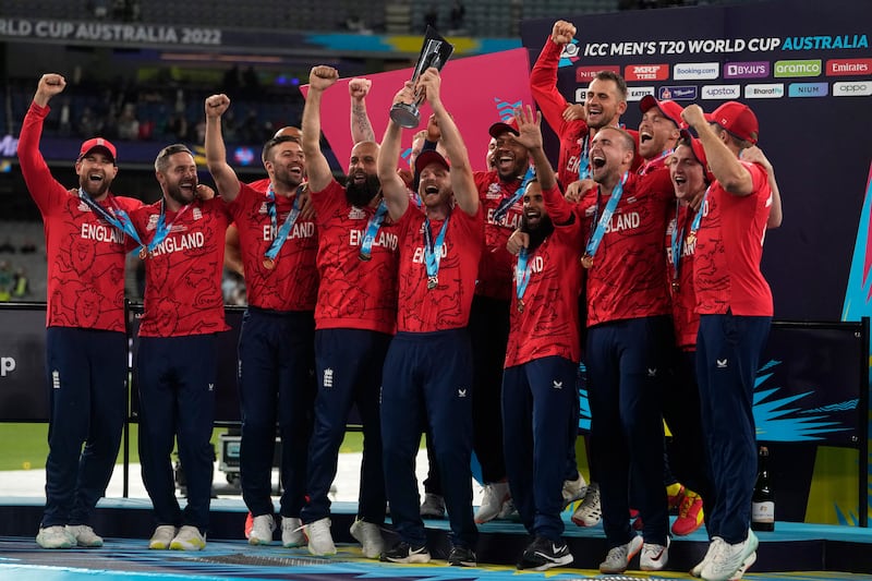England players celebrate with the trophy. AP 