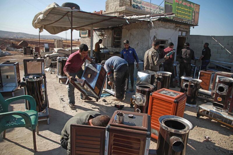 Syrians at a workshop building pistachio-powered heaters in Al Dana town in Syria's north-west province of Idlib . AFP