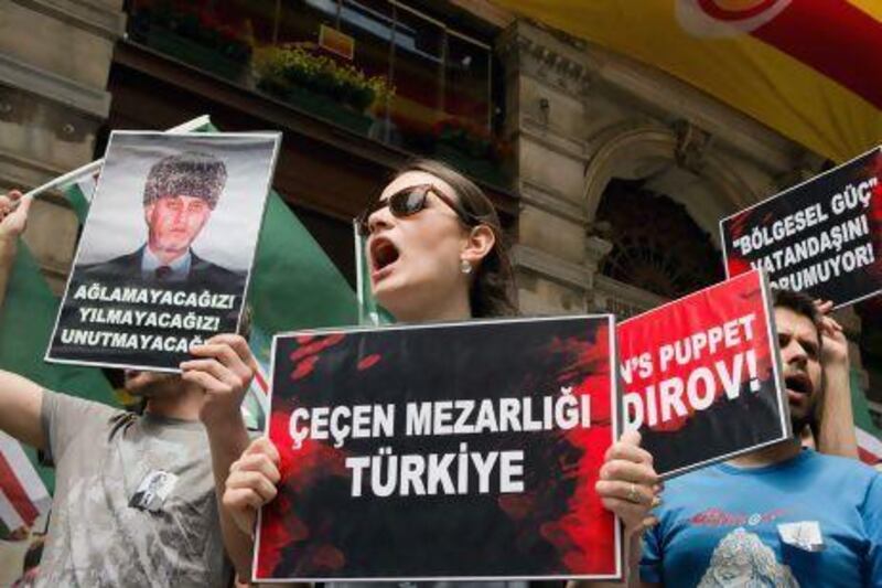 Activists hold a banner at the Russian consulate in Istanbul saying "Turkey is a graveyard for Chechens" after a businessman was murdered in Ankara.