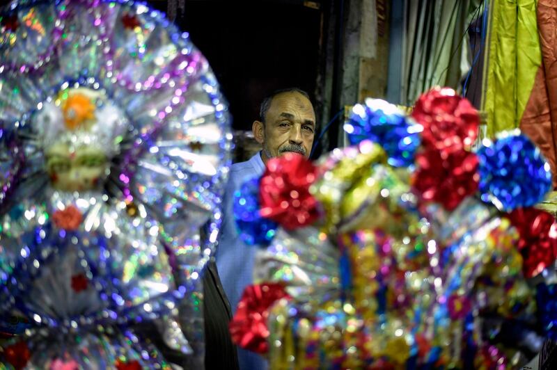 An Egyptian vendor sits behind his confectionery store in Cairo. AFP