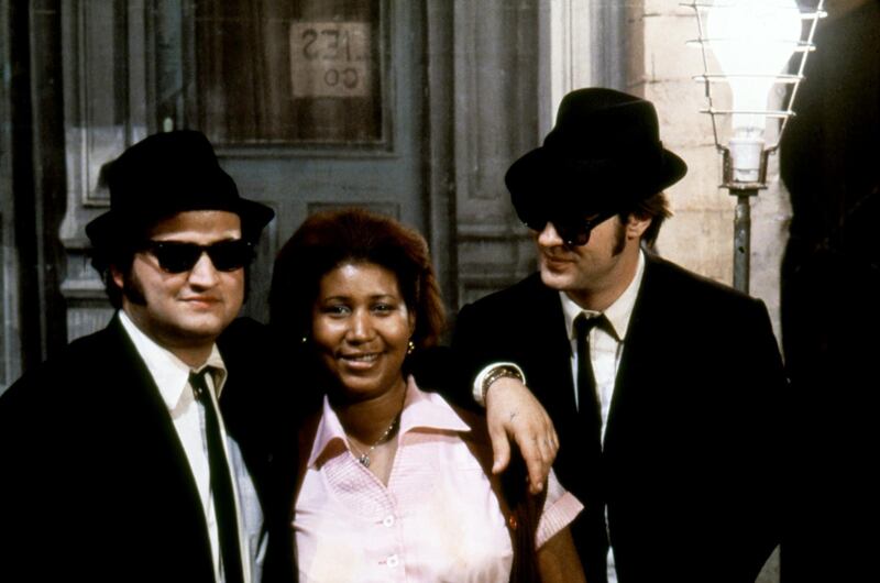 American singer, songwriter, and pianist Aretha Franklin surrounded by actor John Belushi and Canadian actor and screenwriter Dan Aykroyd on the set of The Blues Brothers directed by John Landis. (Photo by Sunset Boulevard/Corbis via Getty Images)