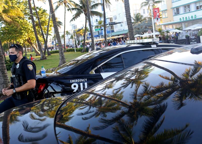 Miami Beach police stand by as people enjoy the bars and restaurants on South Beach during Spring Break in Miami, Florida, U.S., March 26, 2021.  REUTERS/Yana Paskova