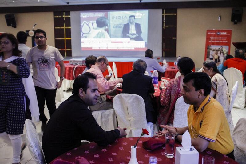 Humit Bhatia, left, and Sanjay Bhayani gathered with others from the Indian expat community living in Dubai at the Indian Club in Bur Dubai yesterday to get election results as they unfolded in India. Antonie Robertson / The National