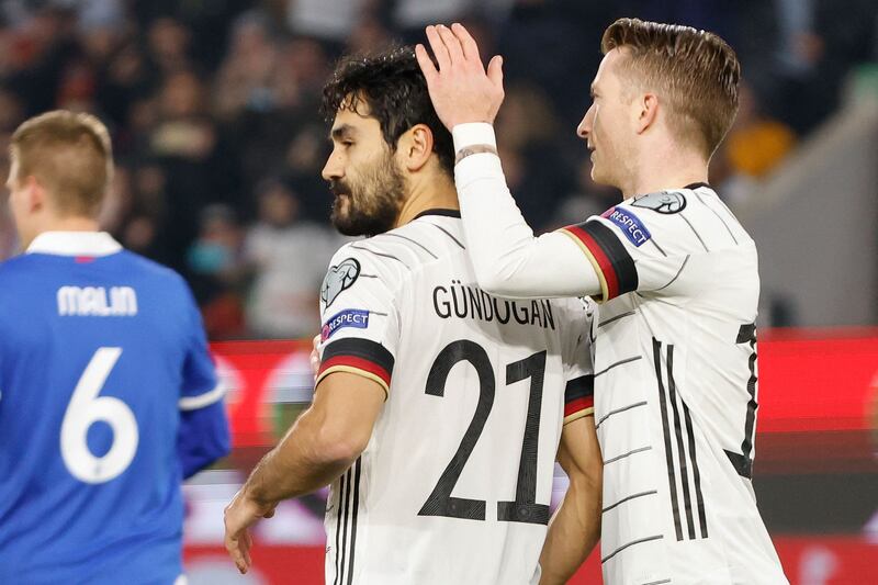 Germany midfielder Ilkay Gundogan celebrates scoring the opening goal from the penalty spot with his teammate Marco Reus. AFP