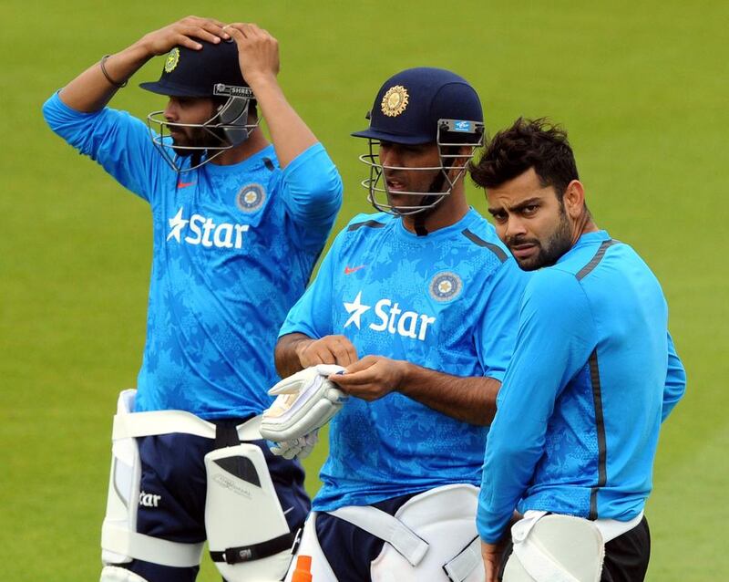MS Dhoni, centre, feels Ravindra Jadeja, left, is talented and can be handy when he starts ‘being himself’ on the field. Rui Vieira / AP Photo