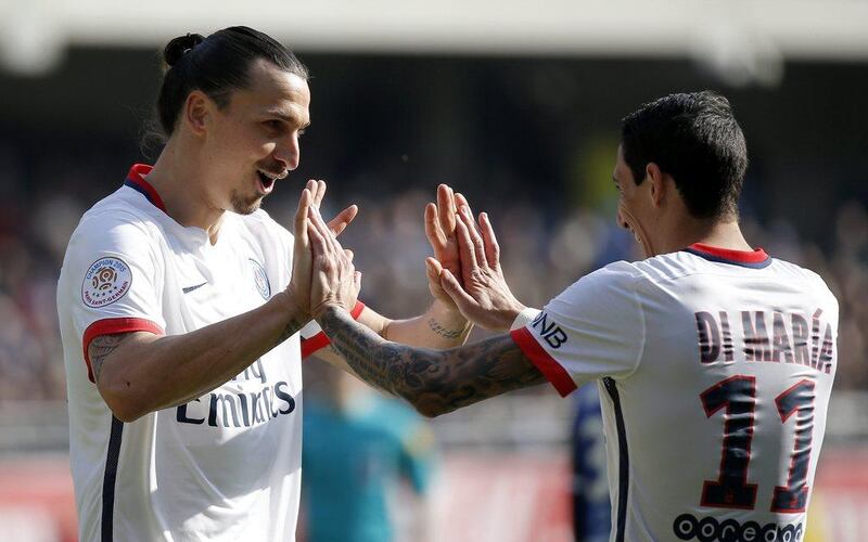 Zlatan Ibrahimovic (L) of Paris Saint Germain celebrates with team mate Angel Di Maria (R) after scoring during the French Ligue 1 soccer match between Estac Troyes and Paris Saint-Germain (PSG) at the Aube stadium in Troyes, France, 13 March 2016. PSG clinches 4th straight Ligue 1 title. EPA/YOAN VALAT