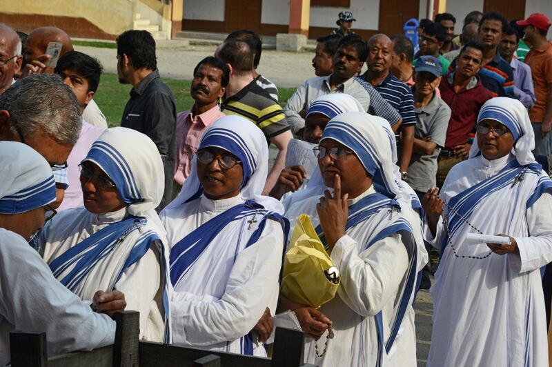 Indian voters queue up to cast their vote at a polling station in Siliguri, West Bengal. AFP