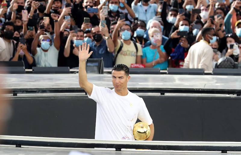 Cristiano Ronaldo waves to fans, many of whom had waited hours for his appearance at the Expo.