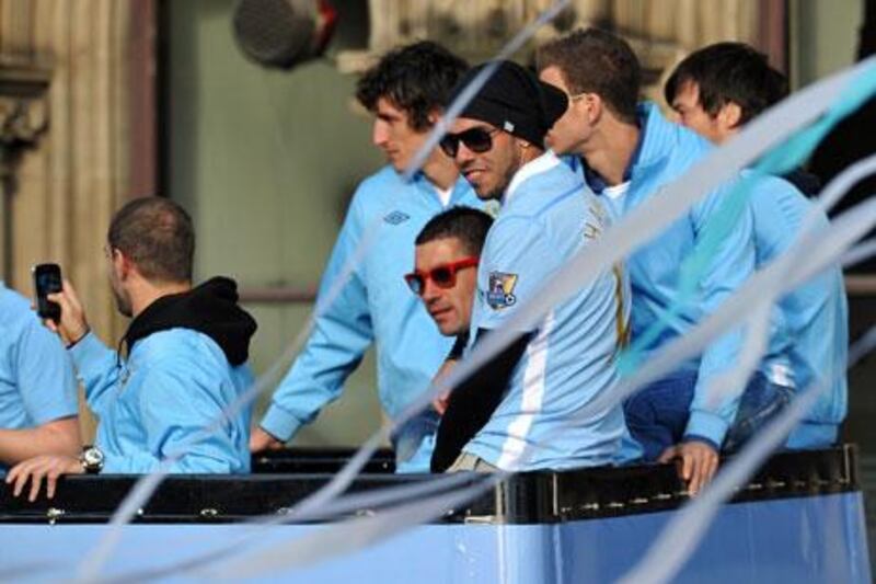 Carlos Tevez, third from right, left Manchester United to join neighbours City in 2009. Paul Ellis / AFP