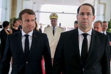 Tunisian Prime Minister Youssef Chahed, right, welcomes French President Emmanuel Macron who attended the funeral ceremony for the country’s first democratically elected president Beji Caid Essebsi. AP