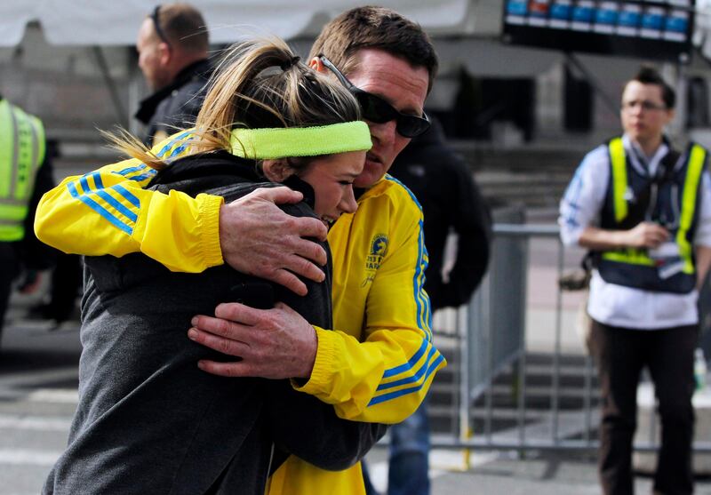 A woman is comforted by a man near a triage tent set up for the Boston Marathon after explosions went off at the 117th Boston Marathon in Boston, Massachusetts April 15, 2013. REUTERS/Jessica Rinaldi (UNITED STATES - Tags: CRIME LAW SPORT ATHLETICS DISASTER) *** Local Caption ***  BOS201_ATHLETICS-MA_0415_11.JPG